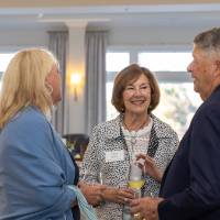 Joan Nowak chatting with two other event attendees